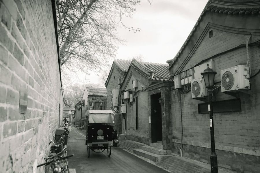Traditional Beijing hutong alley with grey brick courtyard homes