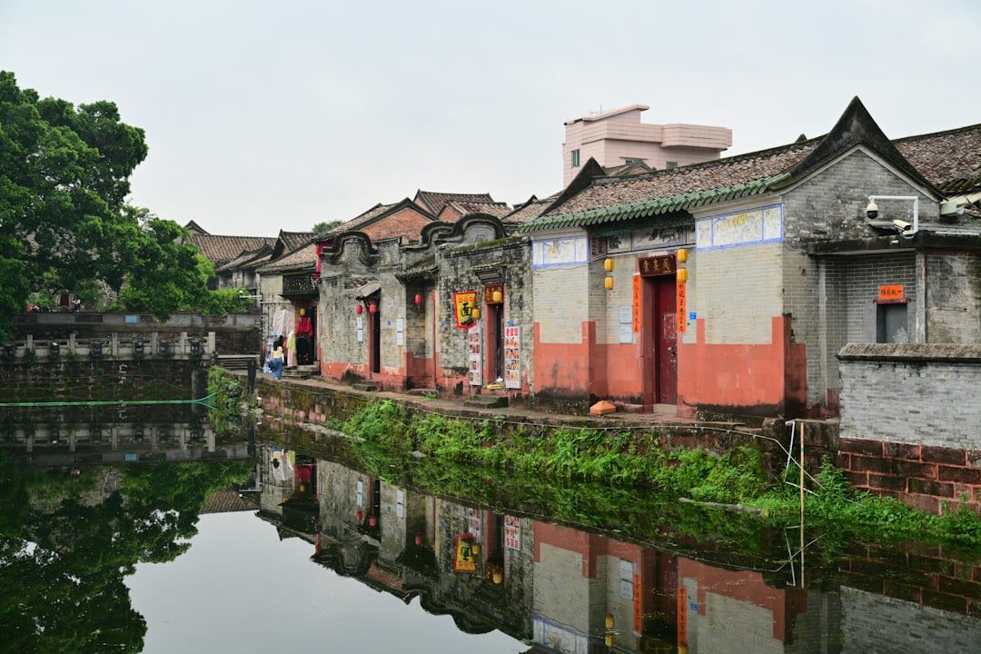 Traditional Chinese rural village with stone houses and mountain backdrop
