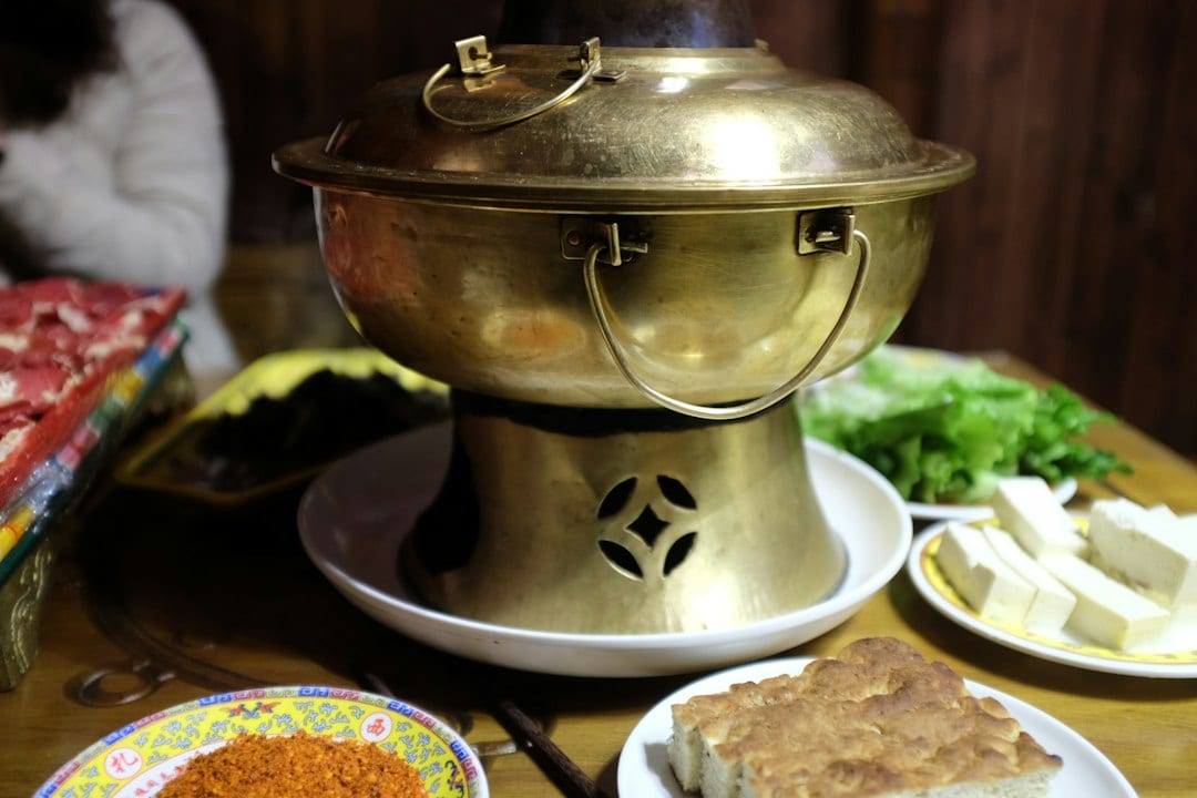 Brass Mongolian hot pot filled with meat and vegetables