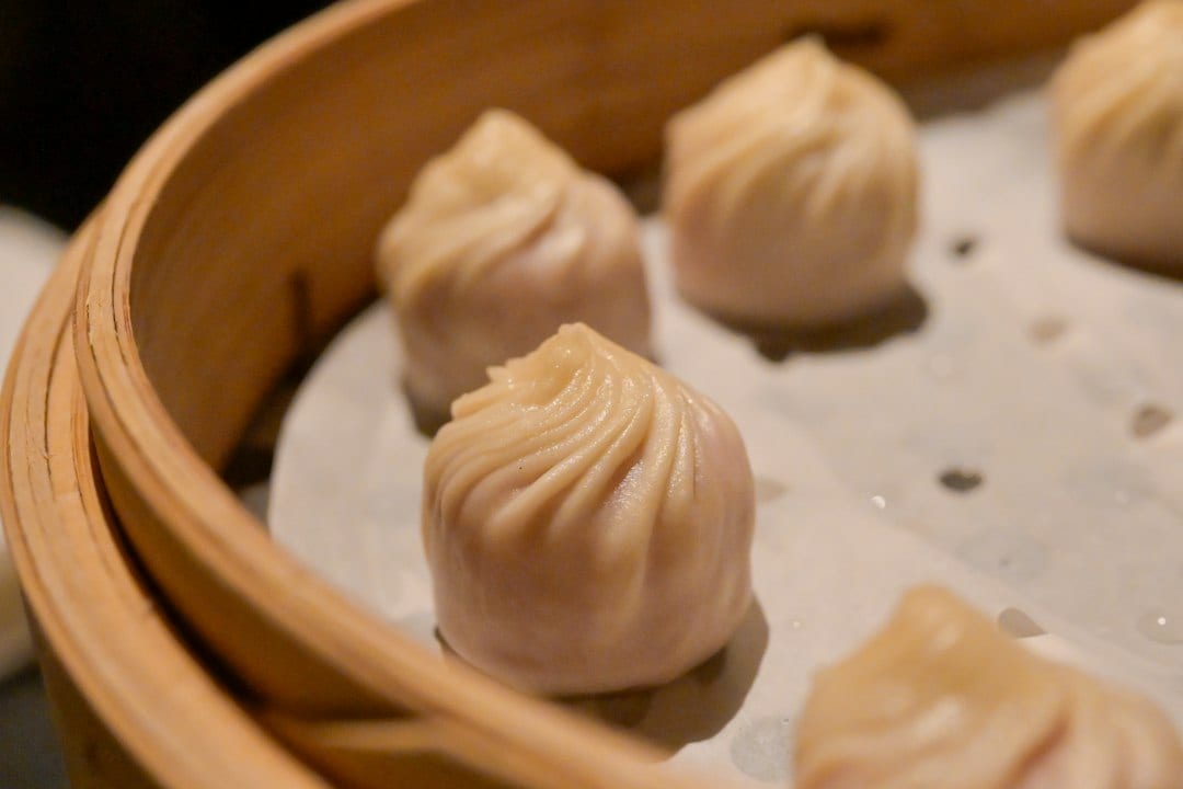 Steamed soup dumplings in bamboo steamer