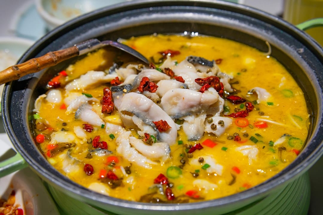 Guizhou sour soup fish hot pot with chili and herbs