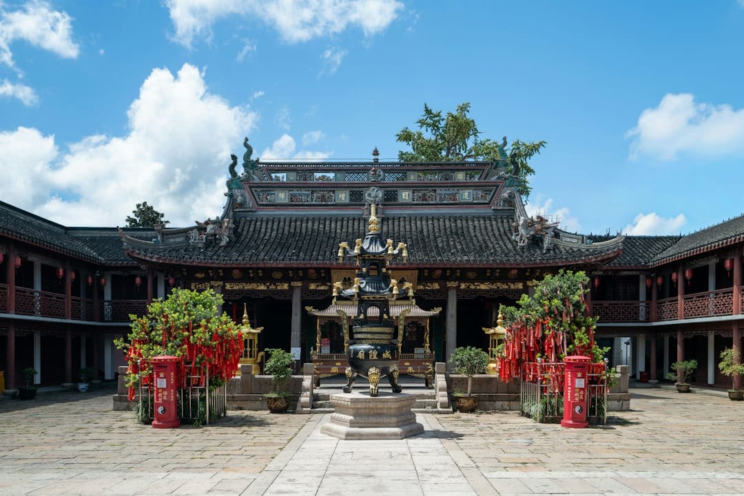 Ancient Chaoshan temple courtyard with incense and lanterns
