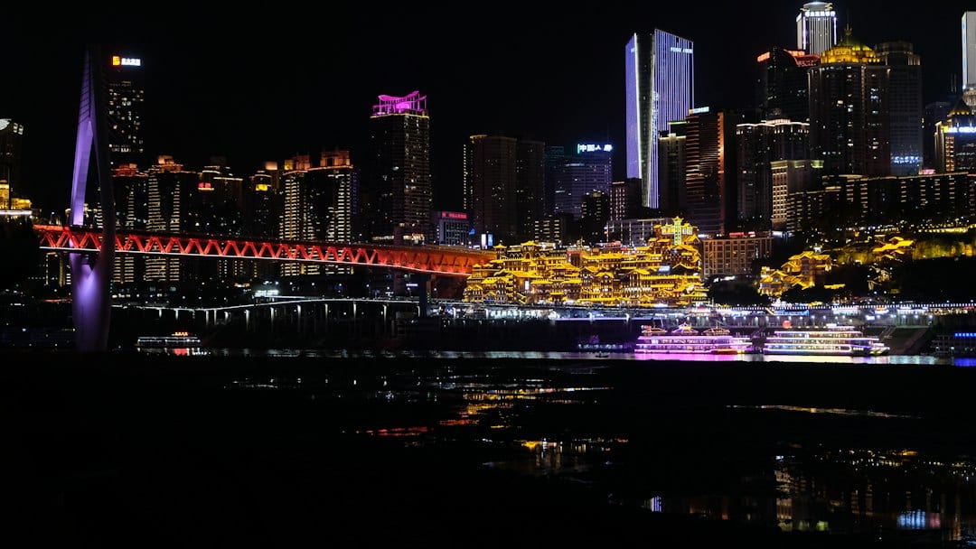 Hongya Cave illuminated stilt houses at night along the Jialing River in Chongqing