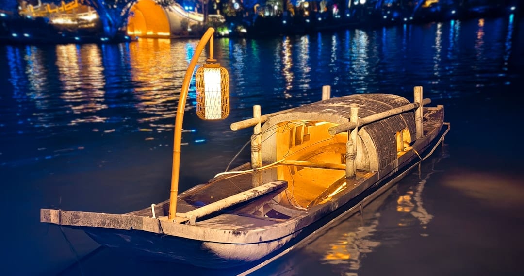 Traditional cormorant fisherman with lantern on Li River at night