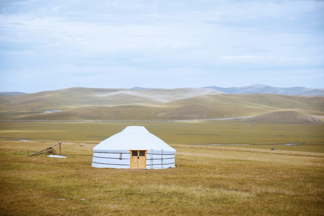 Hulunbuir grassland at sunrise with a traditional yurt