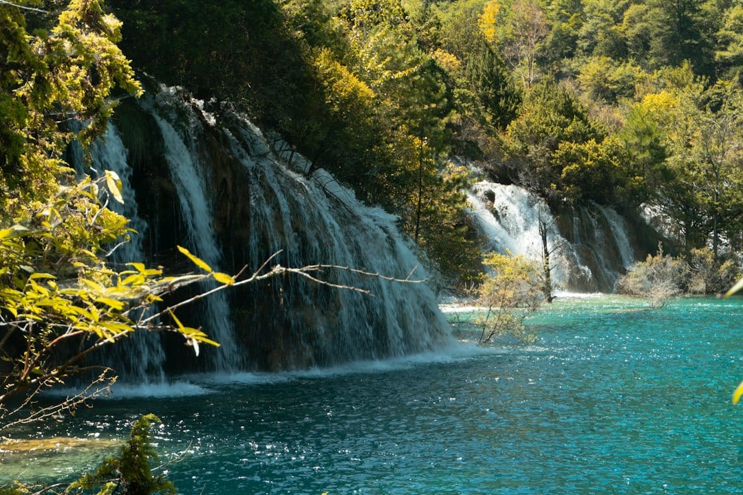 Jiuzhaigou waterfalls flowing into turquoise water