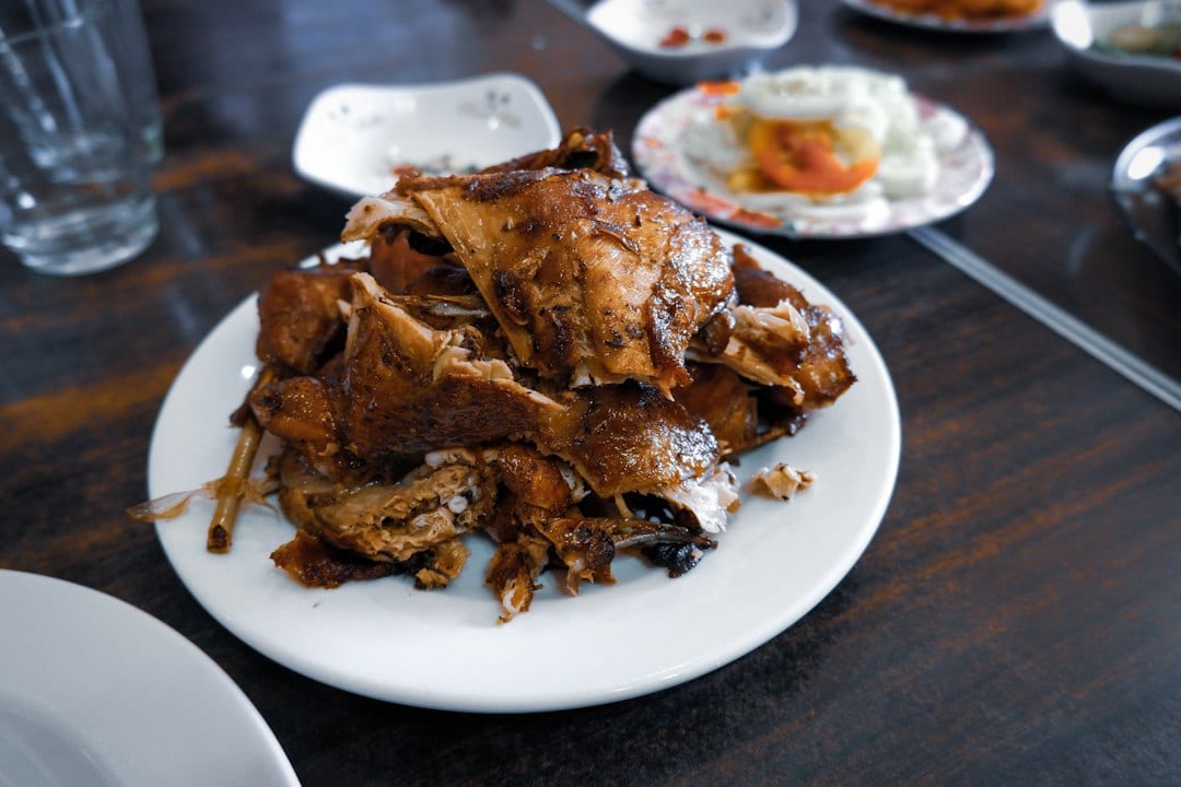 Golden roasted Mongolian lamb leg on a board