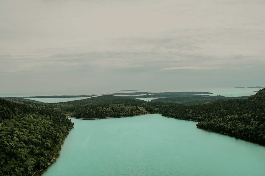 Sayram Lake with crystal blue water surrounded by Tianshan mountains