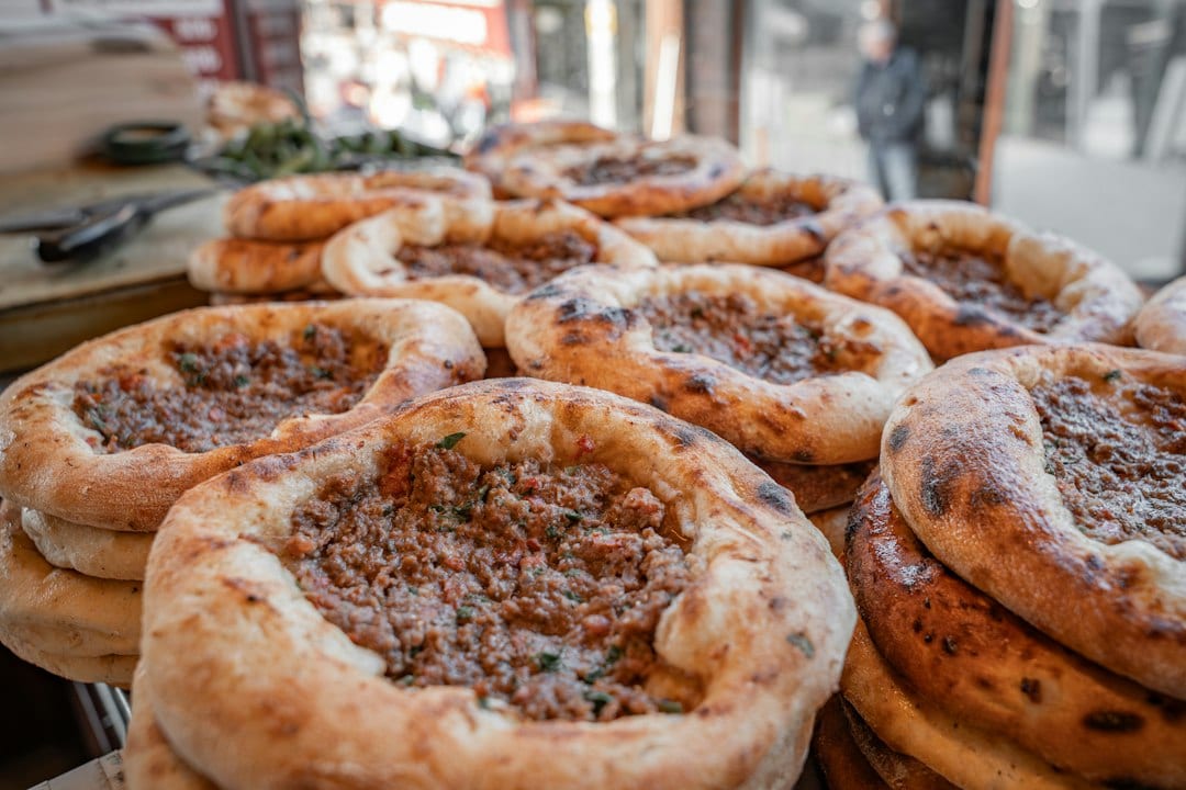 Freshly baked Tibetan shabalep meat pies stacked on a counter