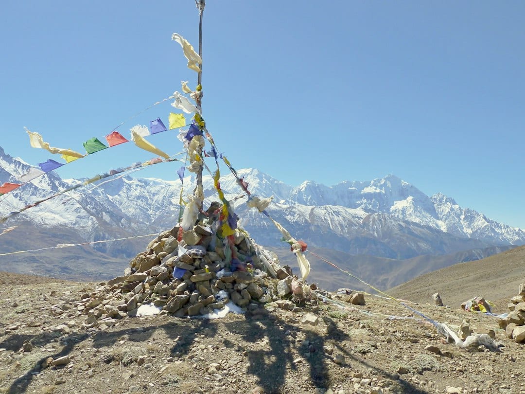 Colorful prayer flags fluttering at a high mountain pass