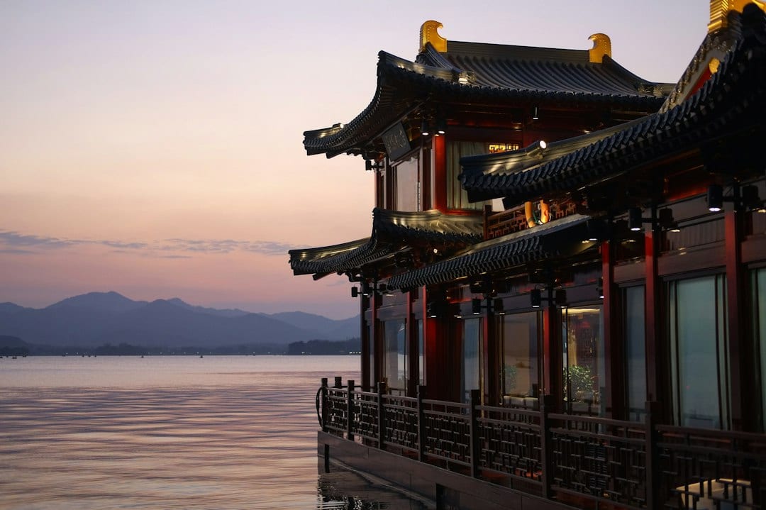 West Lake Hangzhou sunset with golden pavilion reflection