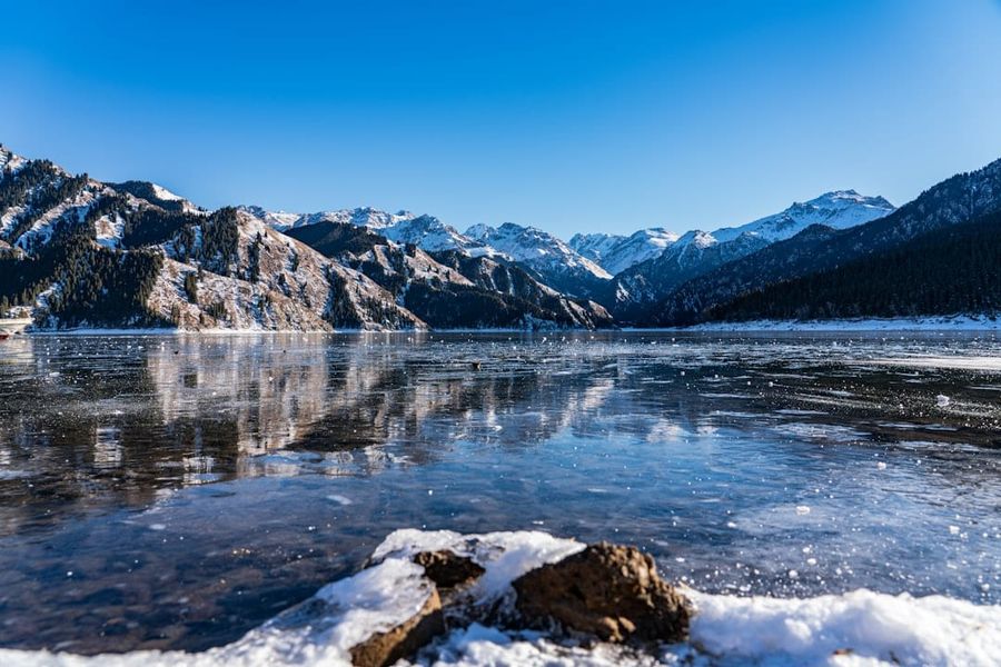 Heavenly Lake Tianchi with snow-capped mountains reflected in water